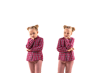 Image showing Young handsome girl arguing with herself on white studio background.