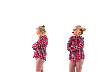 Image showing Young handsome girl arguing with herself on white studio background.