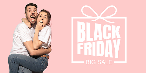 Image showing Portrait of young caucasian couple surprised and shocked of black friday