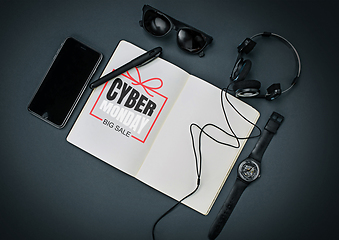 Image showing Top view of gadgets with cyber monday lettering on black background