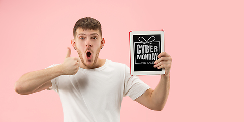 Image showing Portrait of young man showing tablet screen, black friday