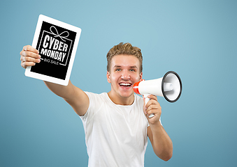 Image showing Portrait of young man showing tablet screen, black friday