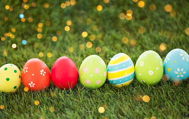 Image showing row of colored easter eggs on artificial grass