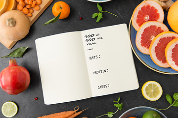 Image showing close up of notebook, fruits and vegetables