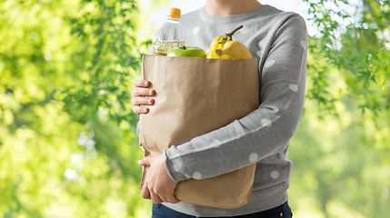 Image showing close up of woman with paper bag full of food