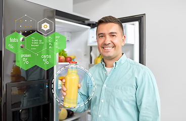 Image showing man taking juice from fridge at home kitchen