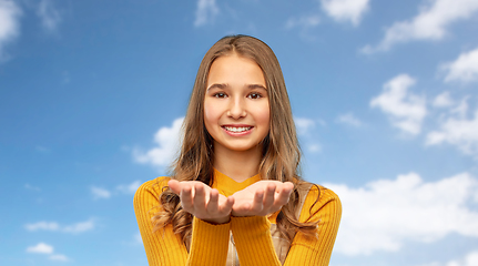 Image showing teenage girl holding something on empty hands