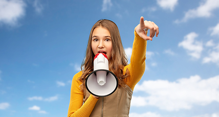 Image showing teenage girl speaking to megaphone over sky