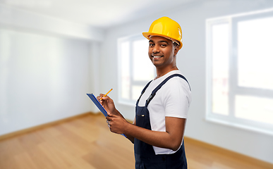 Image showing happy builder in helmet with clipboard and pencil