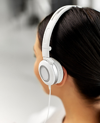 Image showing close up of woman in headphones listening to music