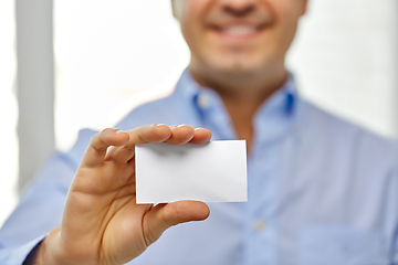 Image showing close up of smiling man holding business card