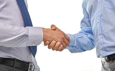 Image showing close up of businessmen making handshake at office