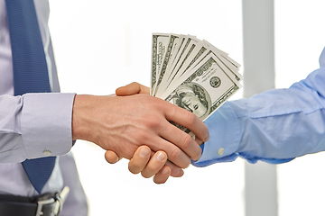 Image showing close up of businessmen's hands holding money