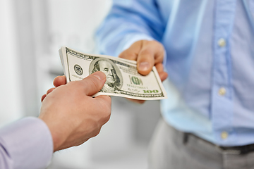 Image showing close up of businessmen's hands holding money