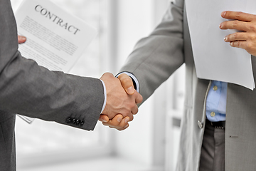 Image showing close up of businessmen making handshake at office