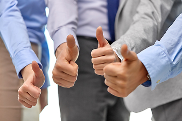 Image showing close up of business team hands showing thumbs up