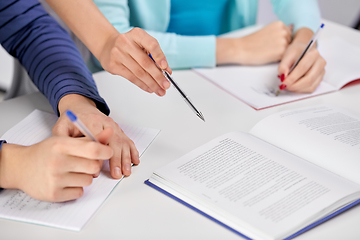 Image showing hands of students with books and notebooks