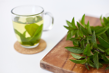 Image showing herbal tea with fresh peppermint on wooden board