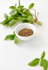 Image showing fresh basil and dry seasoning on white background