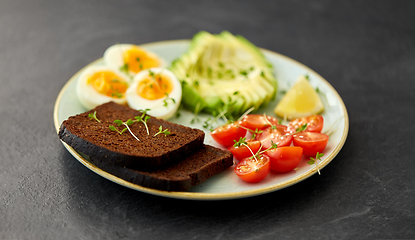 Image showing toast bread with cherry tomato, avocado and eggs