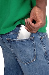 Image showing Black man putting cell phone in back pocket