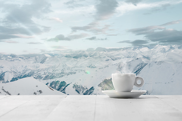 Image showing Single tea or coffee cup and landscape of mountains on background