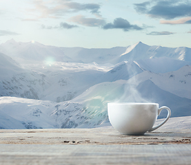 Image showing Single tea or coffee cup and landscape of mountains on background