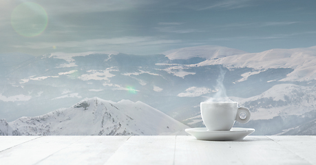 Image showing Single tea or coffee cup and landscape of mountains on background