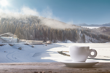 Image showing Single tea or coffee cup and landscape of mountains on background