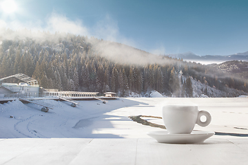 Image showing Single tea or coffee cup and landscape of mountains on background