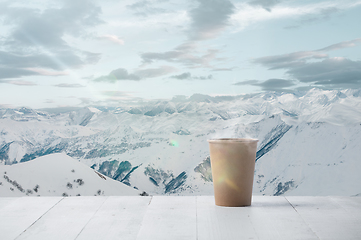 Image showing Single tea or coffee mug and landscape of mountains on background