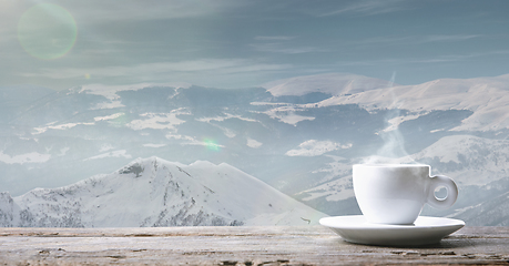 Image showing Single tea or coffee cup and landscape of mountains on background