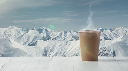 Image showing Single tea or coffee mug and landscape of mountains on background