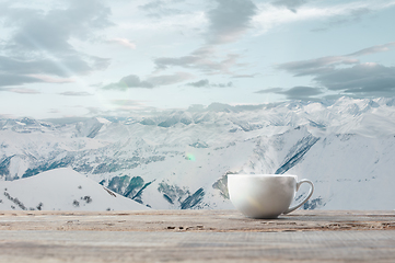 Image showing Single tea or coffee cup and landscape of mountains on background