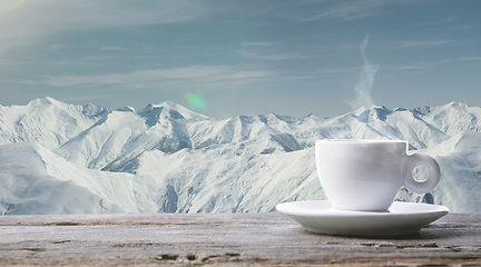 Image showing Single tea or coffee cup and landscape of mountains on background