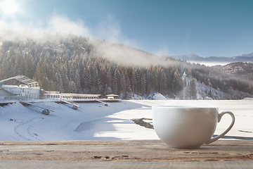 Image showing Single tea or coffee cup and landscape of mountains on background