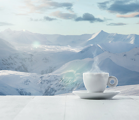 Image showing Single tea or coffee cup and landscape of mountains on background