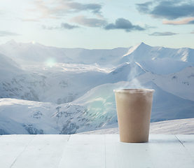 Image showing Single tea or coffee mug and landscape of mountains on background