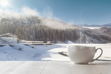 Image showing Single tea or coffee cup and landscape of mountains on background