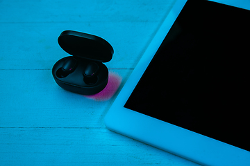 Image showing Top view of set of gadgets in purple neon light