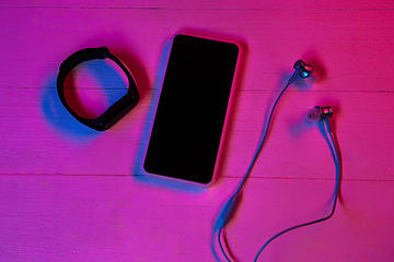 Image showing Top view of set of gadgets in purple neon light