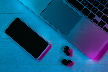 Image showing Top view of set of gadgets in purple neon light