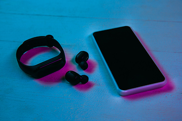 Image showing Top view of set of gadgets in purple neon light