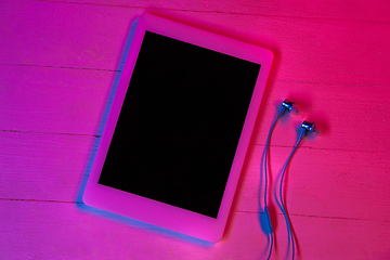 Image showing Top view of set of gadgets in purple neon light