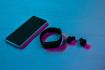 Image showing Top view of set of gadgets in purple neon light