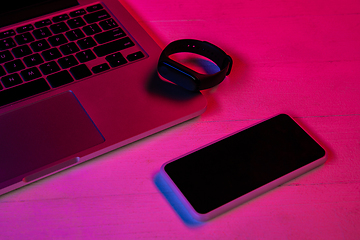 Image showing Top view of set of gadgets in purple neon light