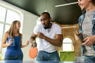 Image showing Young people playing table tennis in workplace, having fun