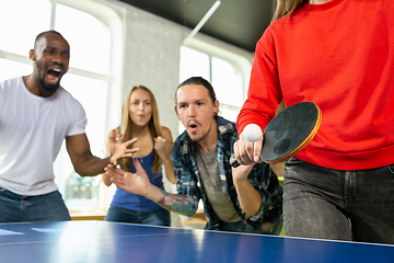 Image showing Young people playing table tennis in workplace, having fun