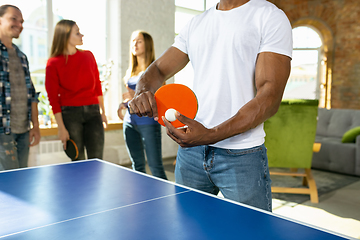 Image showing Young people playing table tennis in workplace, having fun