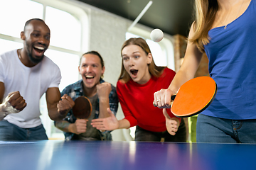 Image showing Young people playing table tennis in workplace, having fun